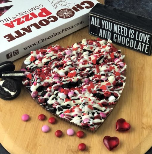 heart chocolate pizza topped with cookies and candy