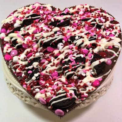 heart chocolate pizza topped with cookies and candy