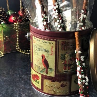chocolate dipped pretzel rods in holiday tin