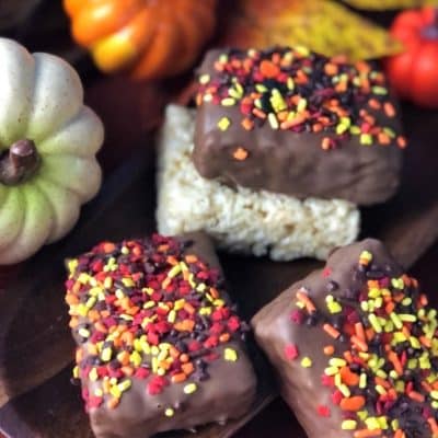 rice crispy square covered in chocolate with autumn color sprinkles