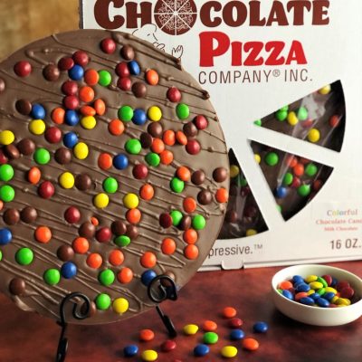 Chocolate Pizza topped with colorful chocolate candy served in a pizza box