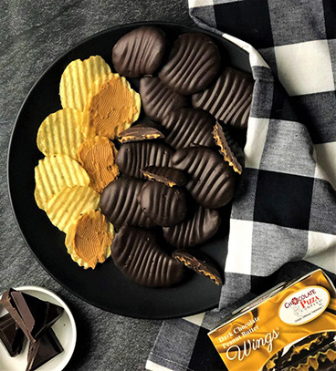 https://www.chocolatepizza.com/wp-content/uploads/2022/05/eci-Dark-Peanut-Butter-Wings-flat-lay-768x849-1.jpg