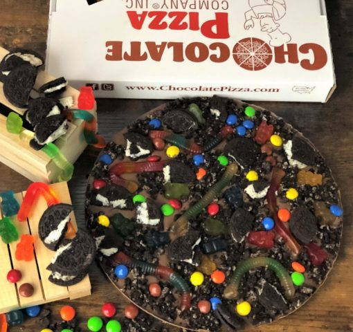 chocolate pizza with gummy worms and cookie pieces
