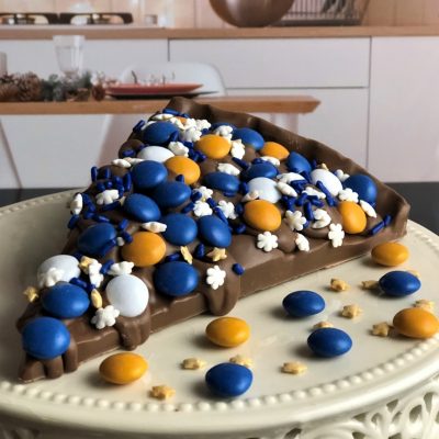 Chocolate Pizza slice with blue and white candies